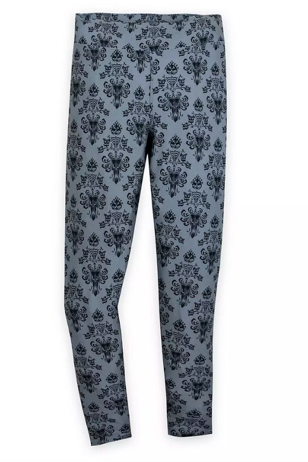 A dusky blue pair of leggings with a black victorian-style print that mimics the wallpaper inside of the Haunted Mansion at Disney World.