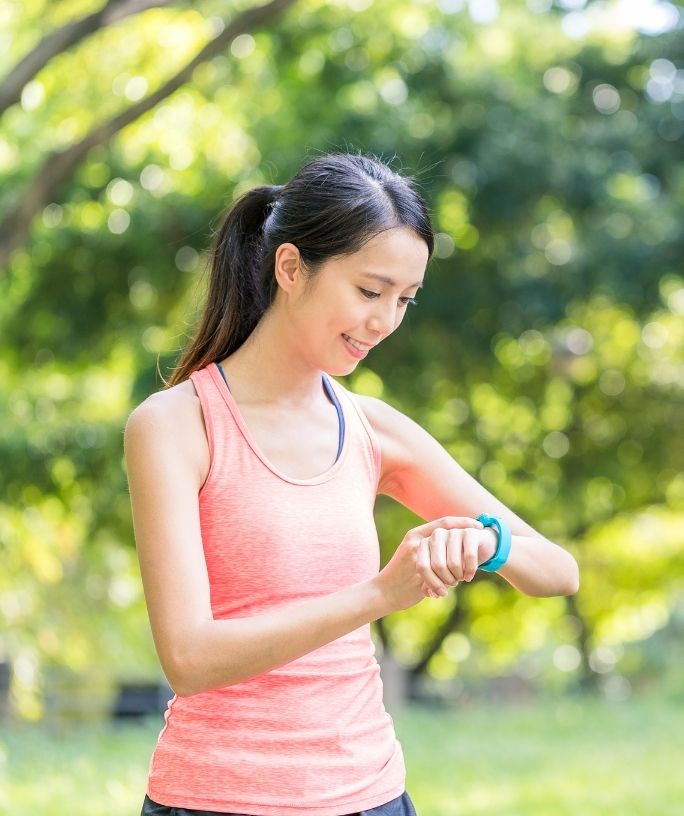 woman looking at her apple watch