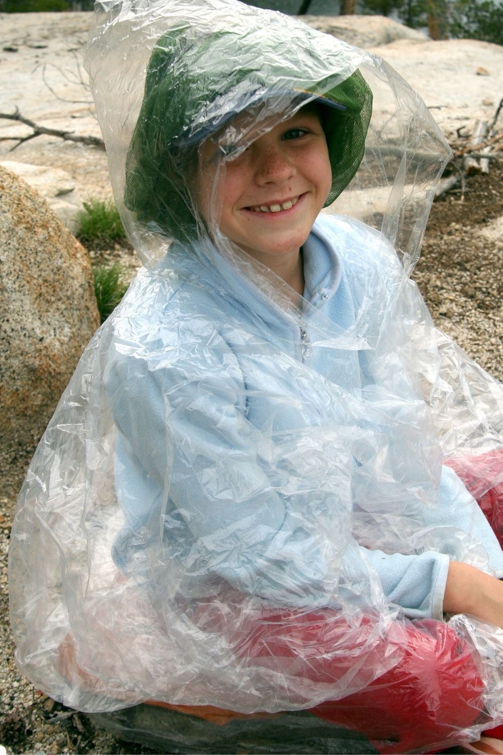 young boy in a rain poncho