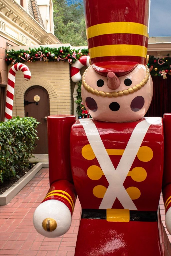 a wooden nutcracker on display during winter at Magic Kingdom