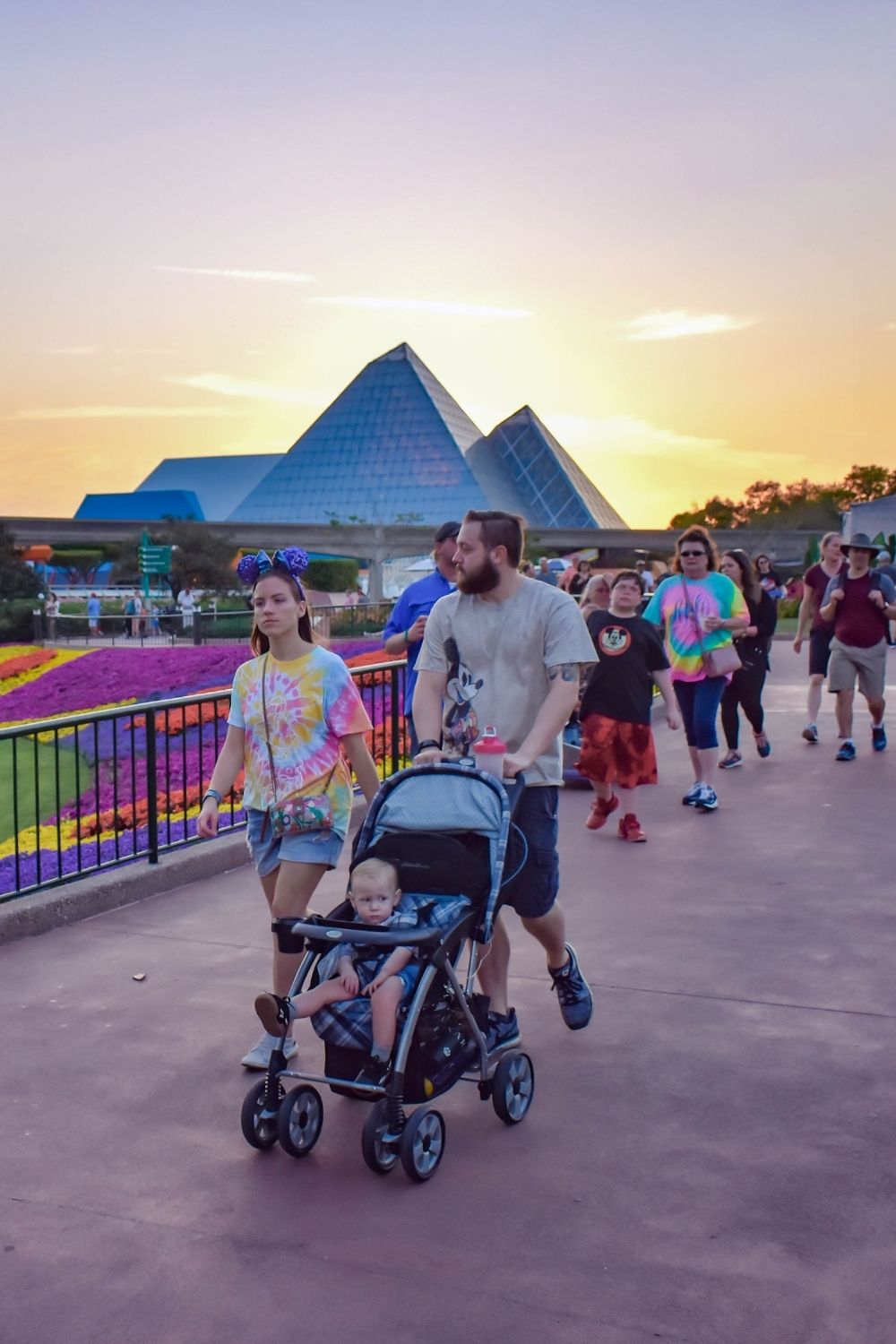 Walt Disney World guests walk through Epcot at sundown.