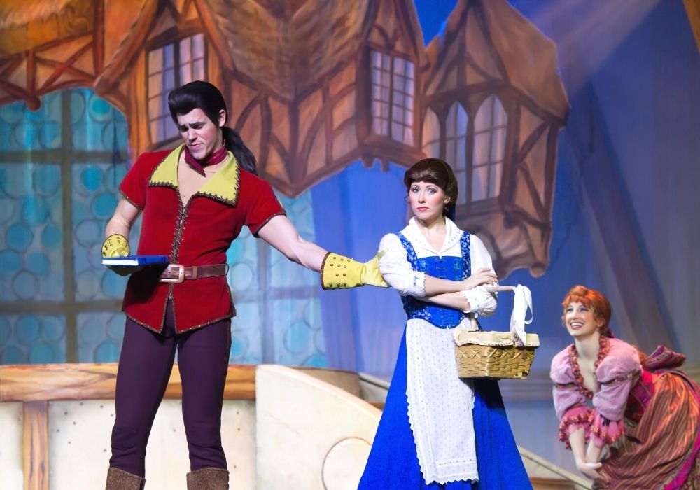 Disney Villain Gaston trying to pull Belle closer to him in the stage performance of Beauty and the Beast at Hollywood Studios in Disney World