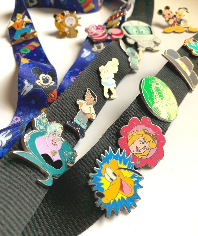 a collection of disney pins attached to lanyards for trading at disney world