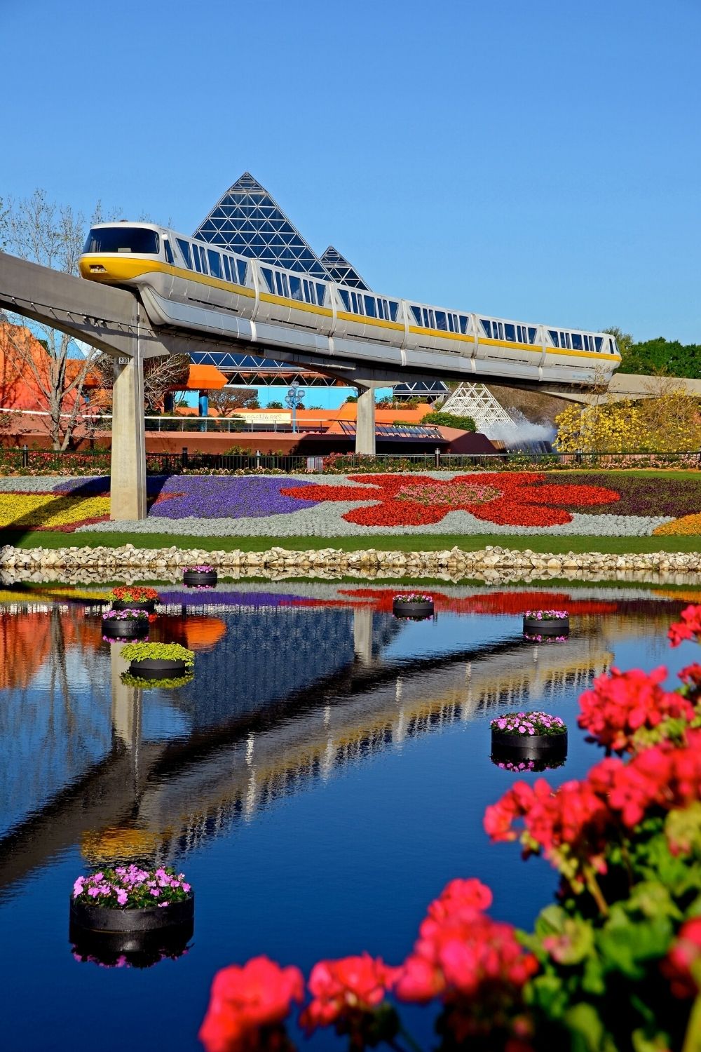 Epcot gardens and pond, with the monorail running overhead