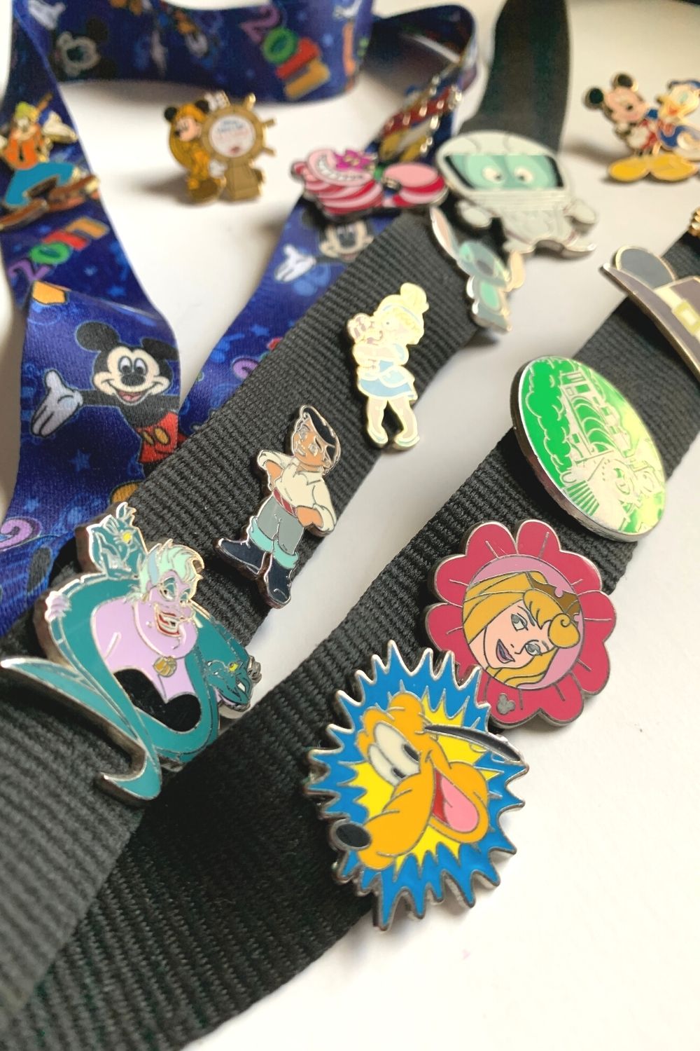 collection of disney pins attached to lanyards