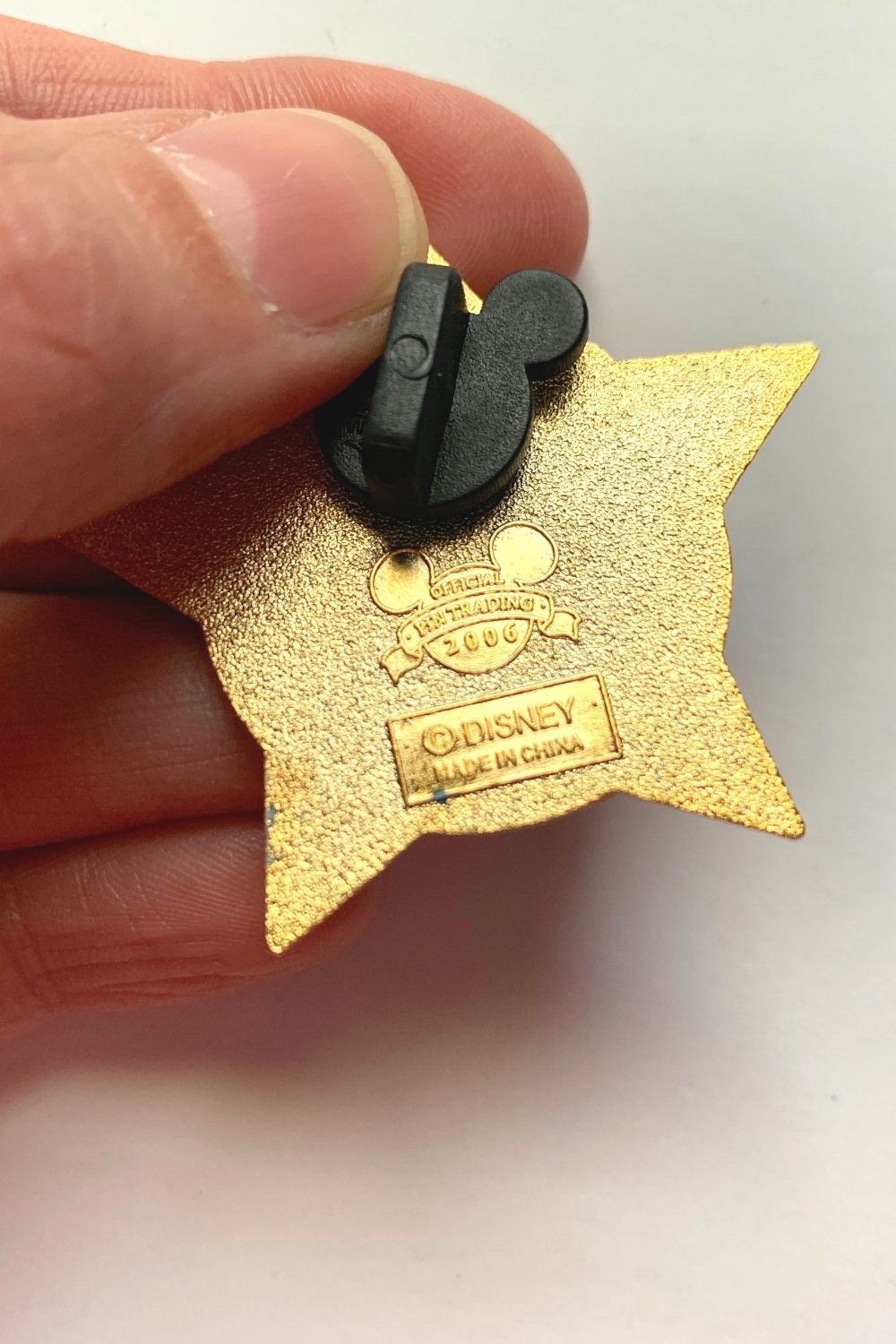 the back of a disney pin, showing the copyright Disney stamp for authenticity