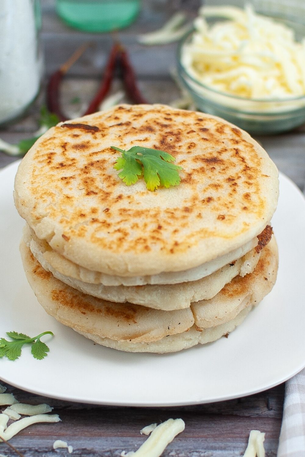 a stack of arepas, like what is served in Encanto, on a white plate