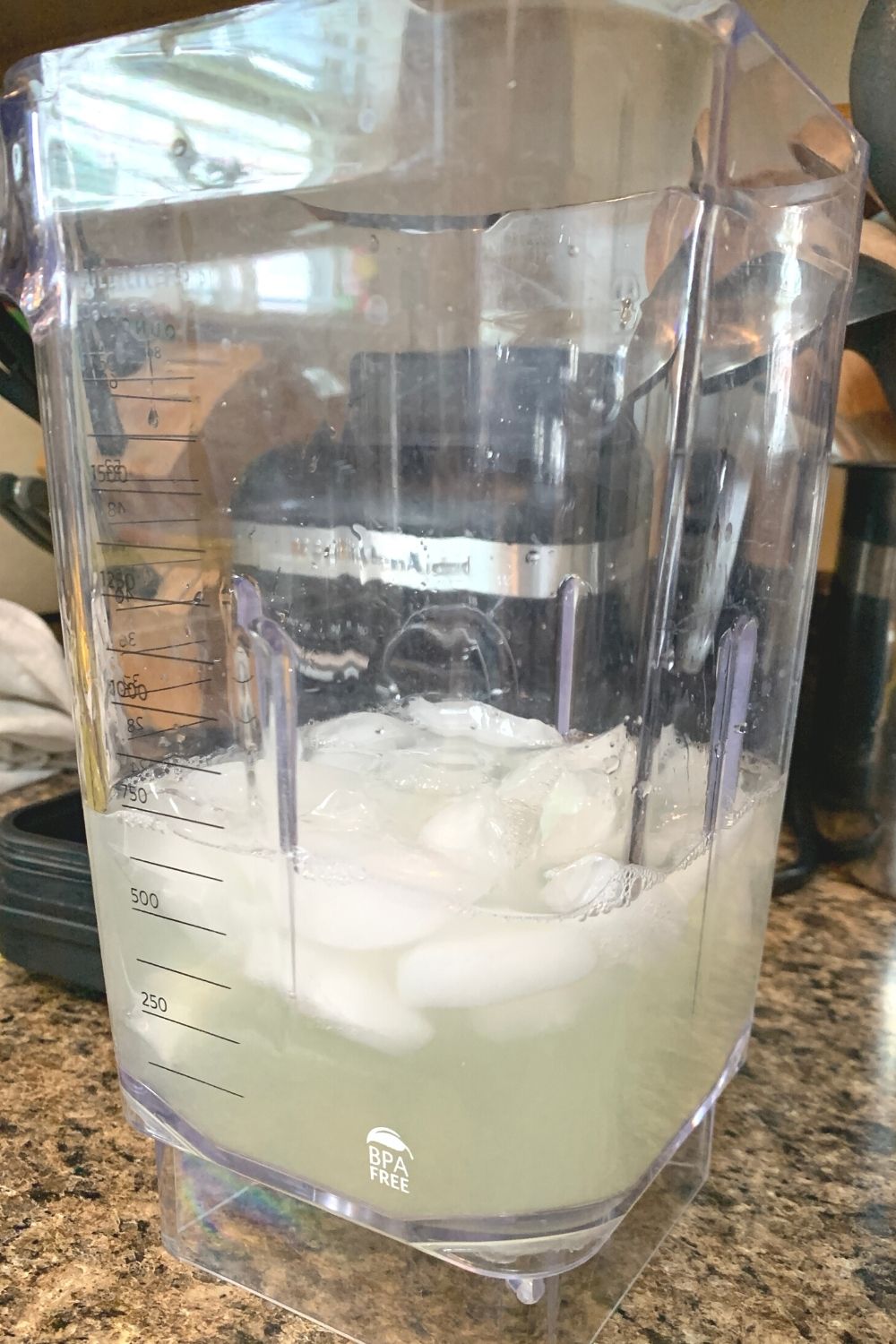 lemon juice, water, and ice cubes in a blender jar