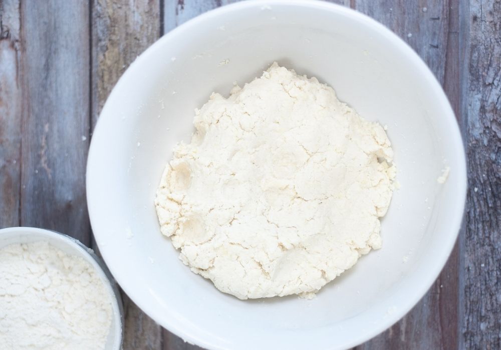 dough for arepas mixed in a white bowl