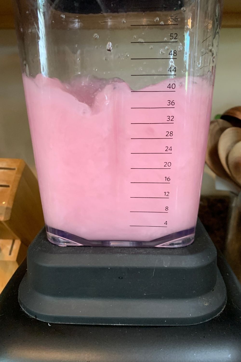 blender mixing ingredients for violet lemonade to a slushy consistency