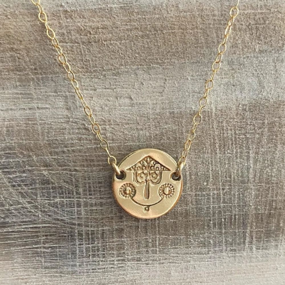 It's a Small World necklace featuring the face of the clock from the ride