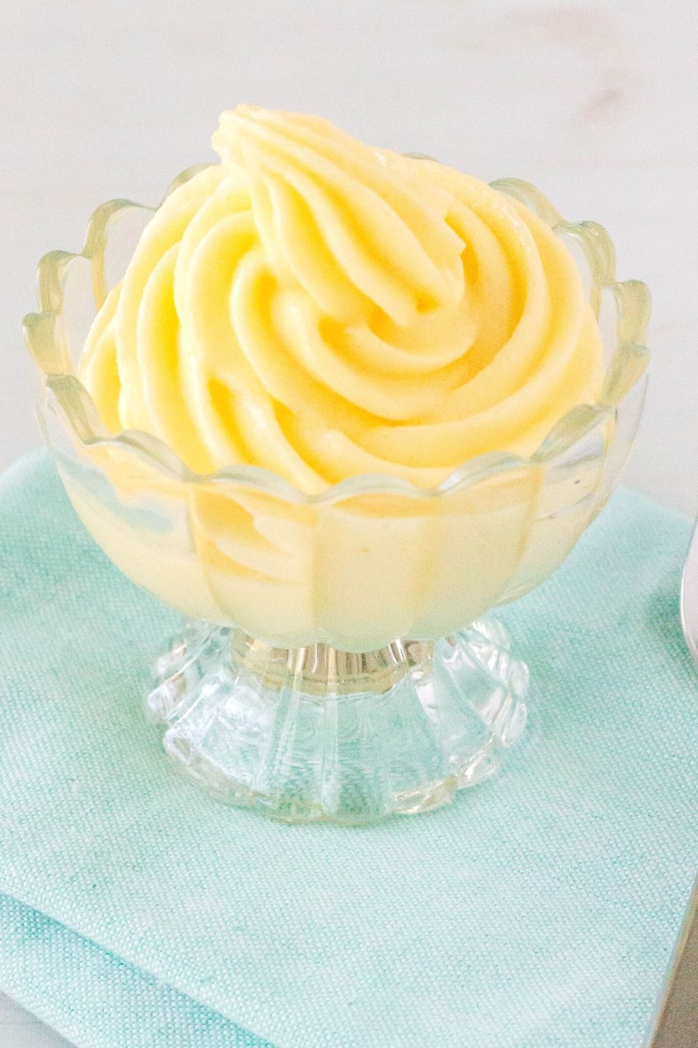 dole whip pineapple soft serve swirled in a glass dessert cup