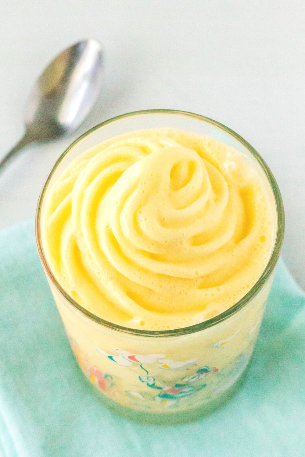 overhead view of the swirl of pineapple dole whip in a Disney glass