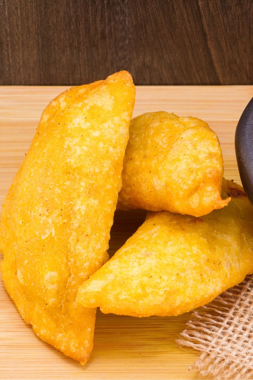 empanadas on a wooden cutting board