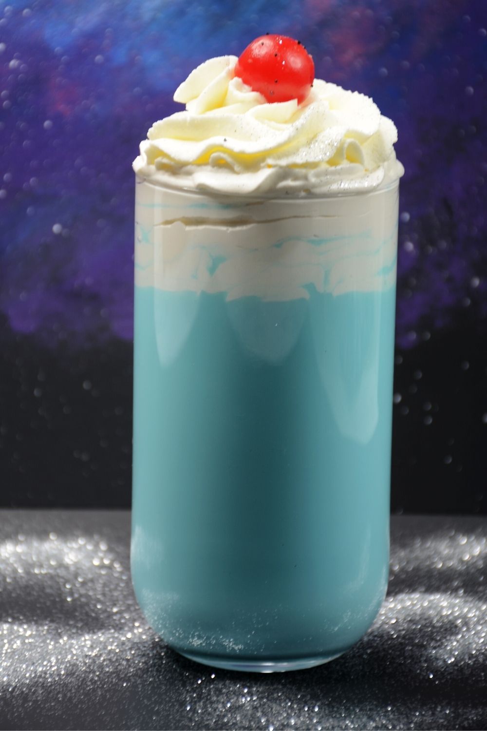 bantha milk served in a glass and topped with whipped cream and a cherry