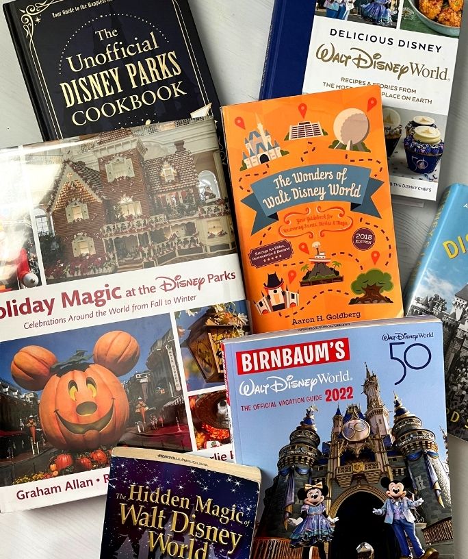 several books about disney stacked together, showing the covers of the books