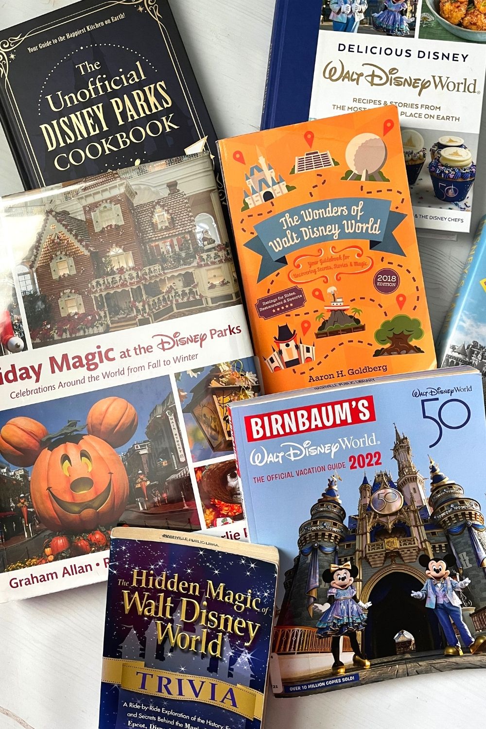 several books about Disney set up together, including two Disney parks cookbooks, a book about holidays at Disney World, a Birnbaum's guide, and a couple of trivia books.