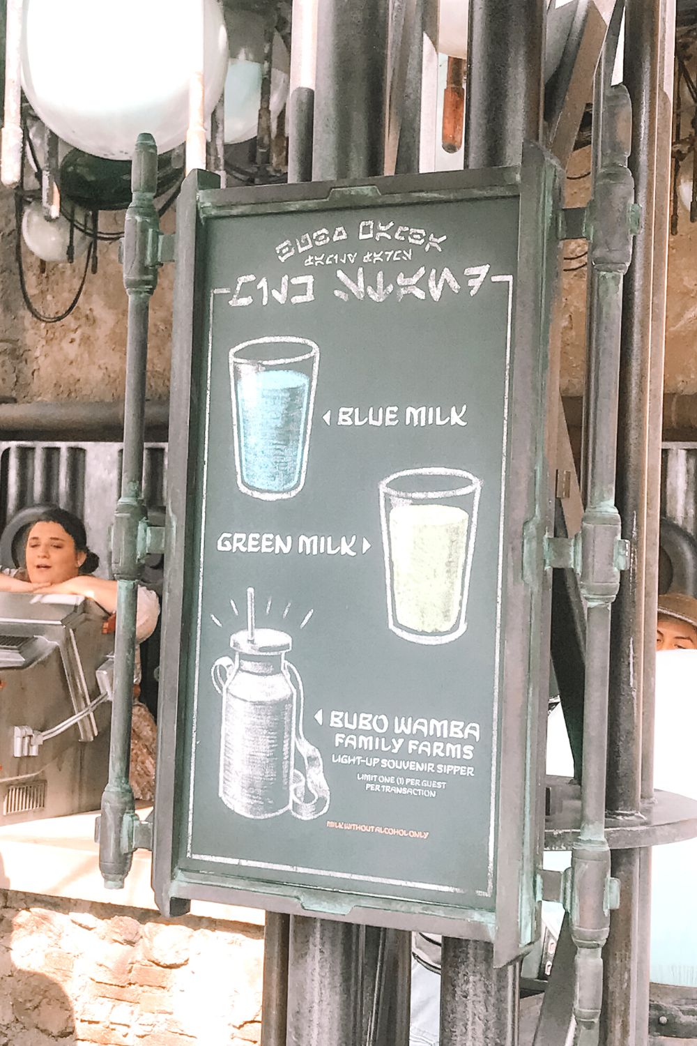 a sign at a Disney restaurant displaying blue milk and green milk