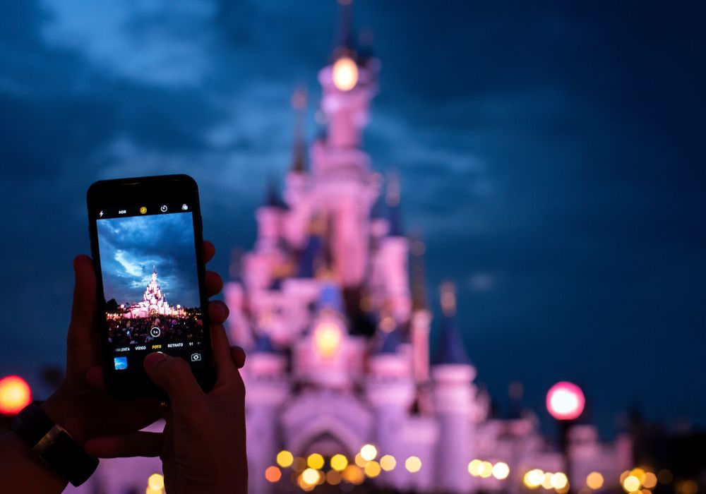 a smart phone is taking a photo of the castle at Disney World
