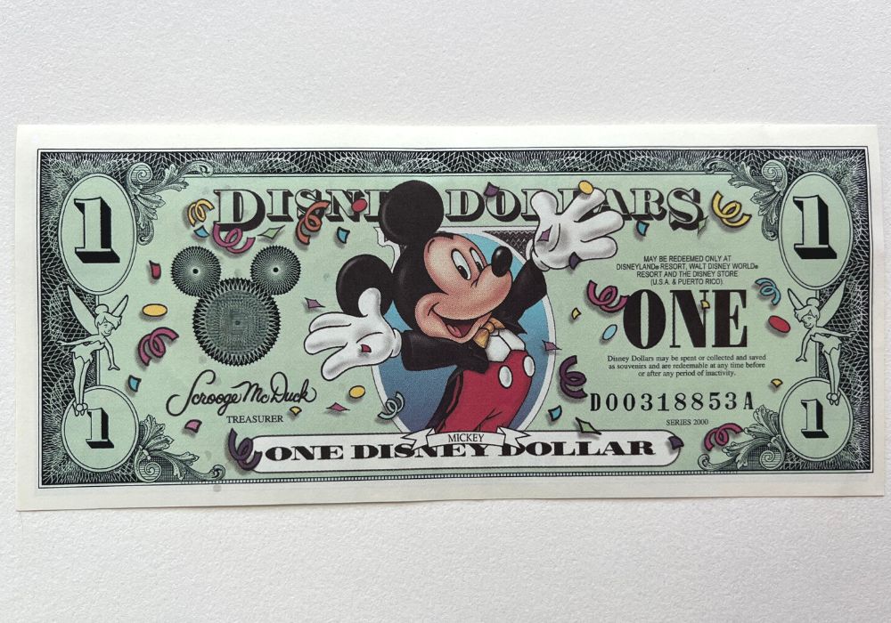close-up view of the front of a Disney Dollar with Mickey Mouse on it