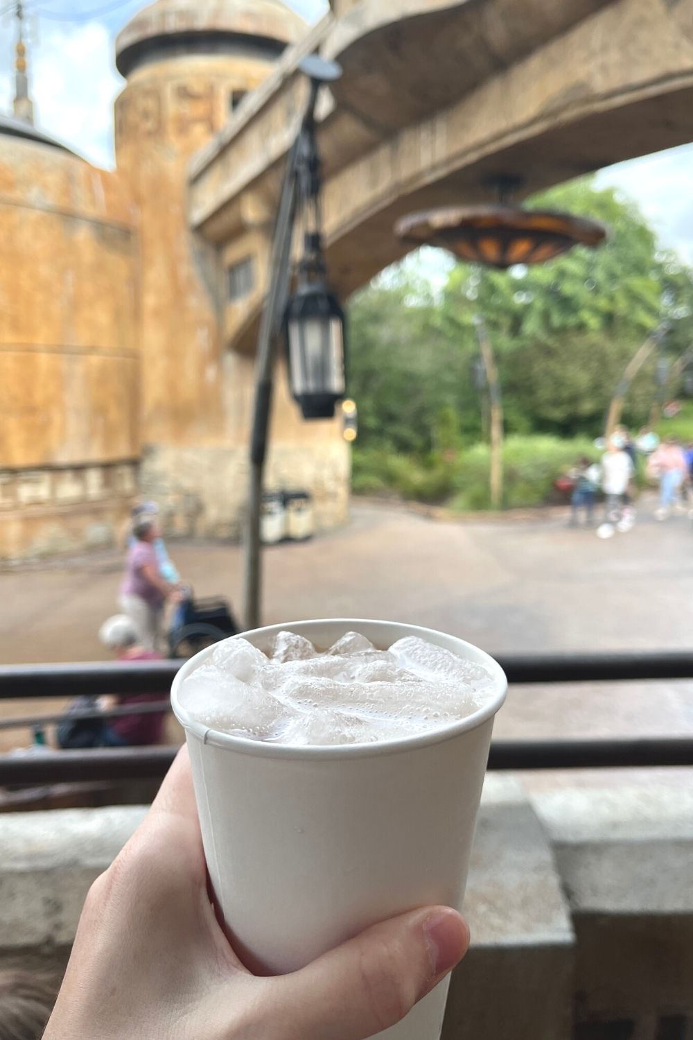 a woman's hand holds a tatooine sunset drink at galaxy's edge in hollywood studios