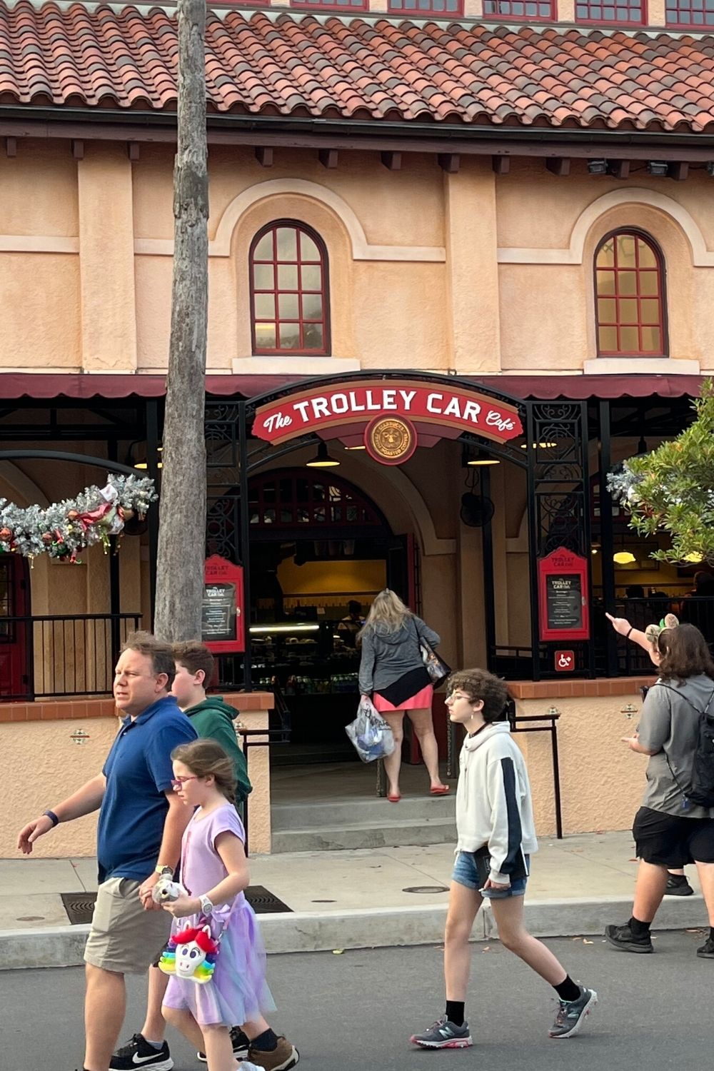 people walk outside of the Trolley Car Cafe at Disney's Hollywood Studios, a great place to grab breakfast