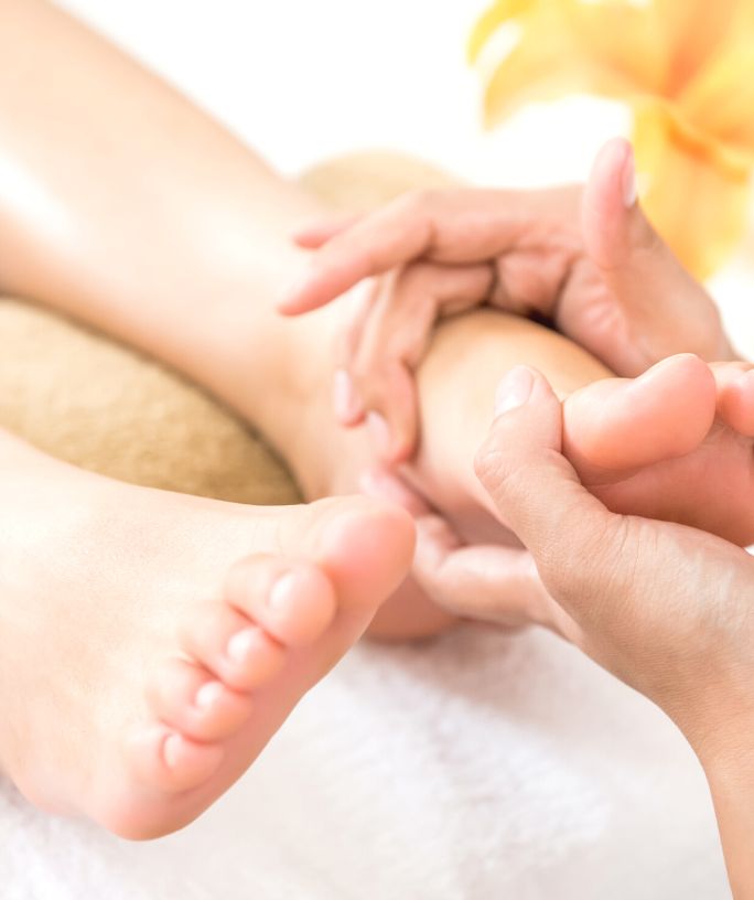 a woman receives a foot massage at a spa