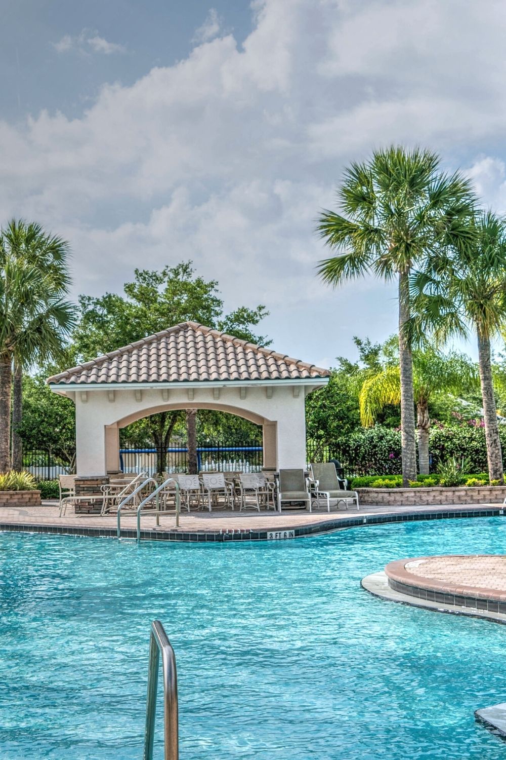 hotel pool with palm trees in the background