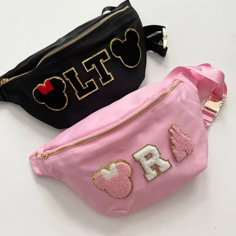 picture of pink and black belt bags with disney themed patches